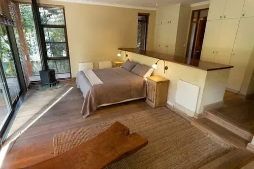 Warm neutral bedroom with clean surfaces and built-in closet storage
