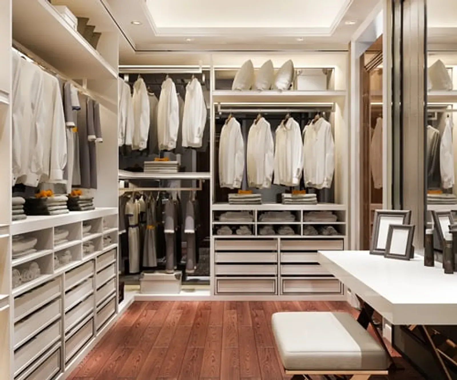Beautifully organized cream walk-in closet with neatly folded and hung clothing