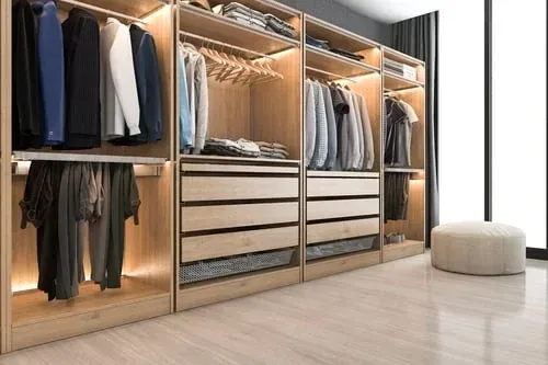 Light oak wardrobe system with hanging clothes, folded stacks and open drawer storage